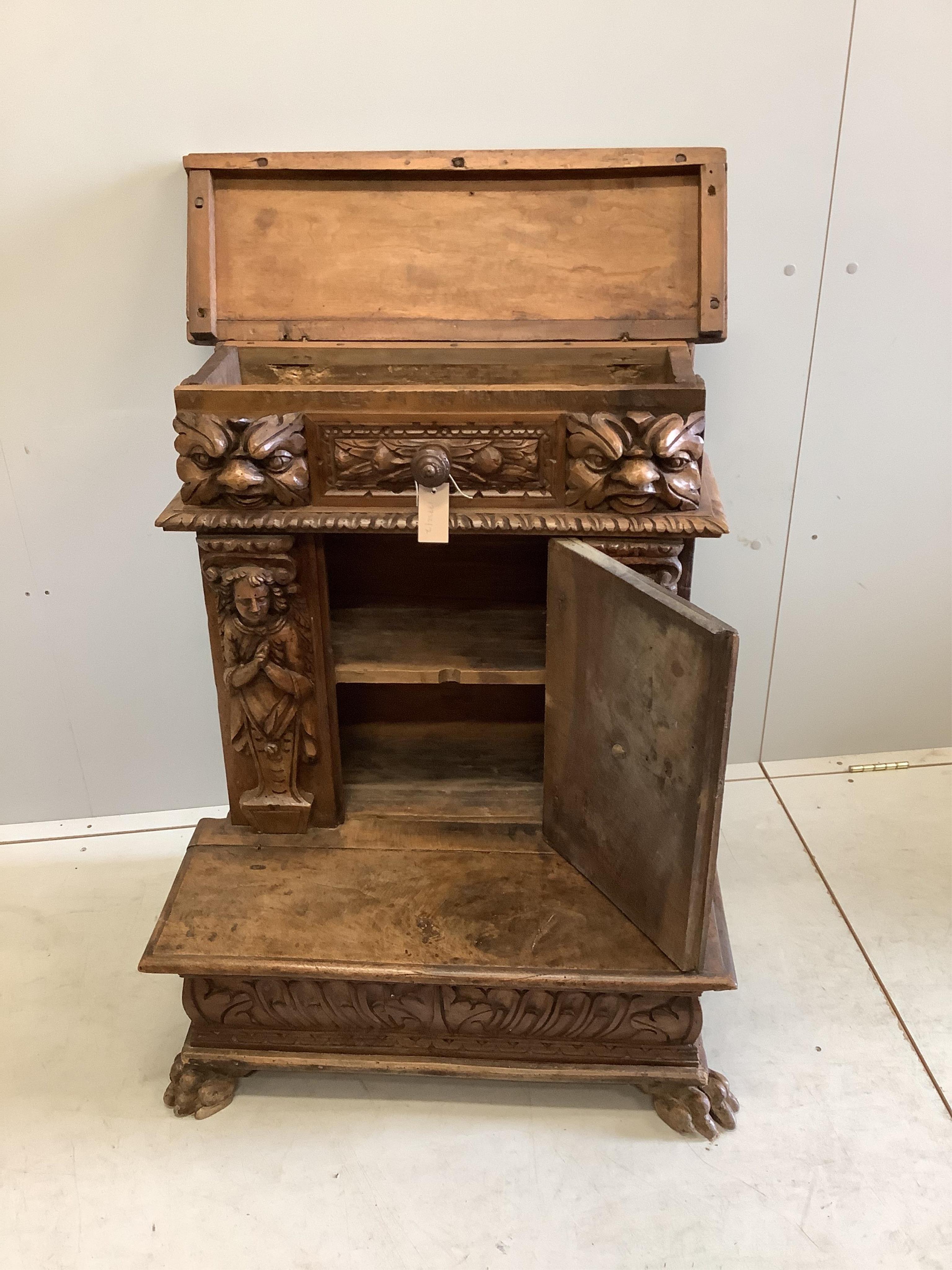An 18th century style Continental carved walnut prie dieu cabinet, width 72cm, depth 49cm, height 90cm. Condition - poor to fair